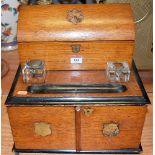 A late Victorian oak and ebonised stationery compendium, having domed top revealing letter rack,