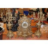 A French style brass cased mantel clock having enamel inset markers with Roman numerals having an 8