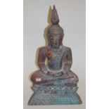 A reproduction carved and painted model of a seated Buddha, h.