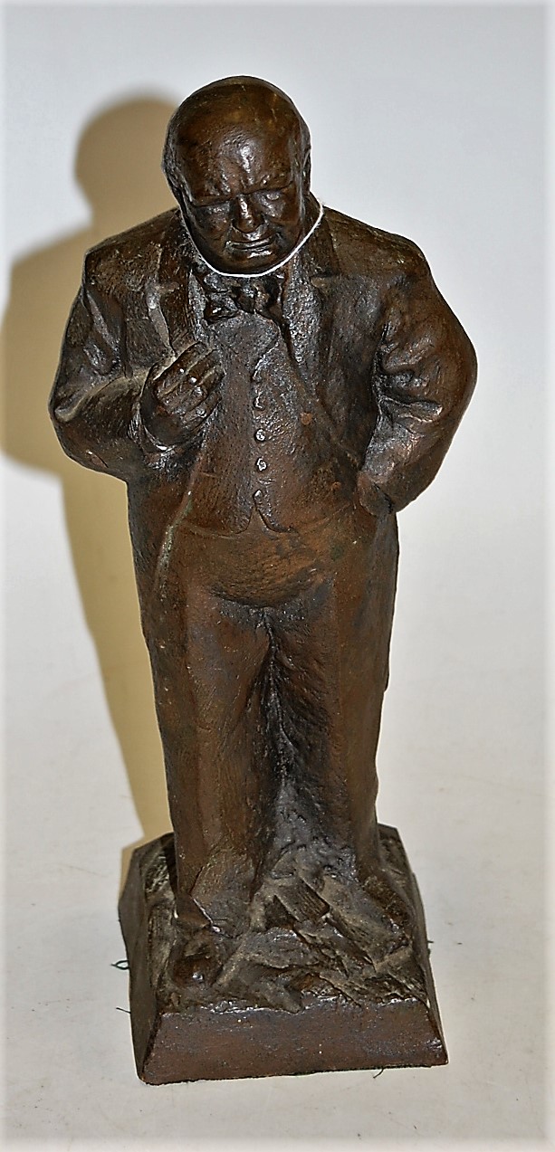 A bronzed plaster figure of Sir Winston Churchill in standing pose, stamped Ravera and dated '73,