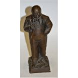 A bronzed plaster figure of Sir Winston Churchill in standing pose, stamped Ravera and dated '73,
