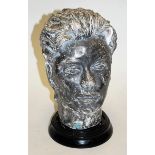 A mid 20th century cast plaster and painted bust of a girl on associated socle base,