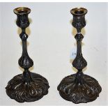 A pair of Victorian pewter candlesticks, each having scrolling acanthus leaf decoration, h.