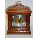 A modern oak cased bracket clock, the silvered dial with Arabic numerals and eight day movement,