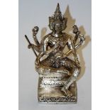 A modern white metal figure of Brahma in seated pose,
