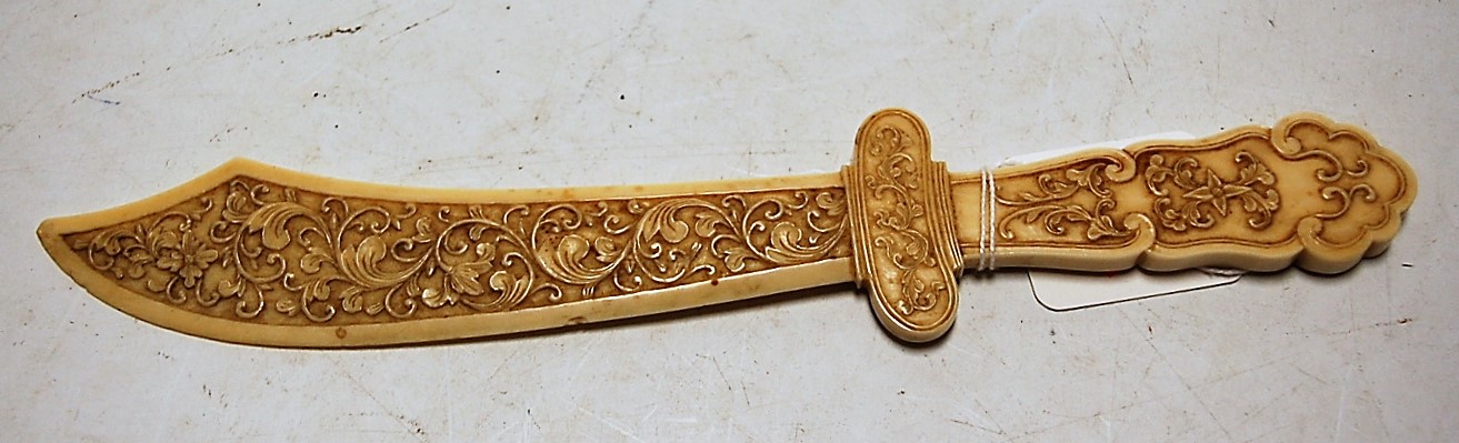 A Chinese Canton carved ivory paperknife in the form of a scimitar,