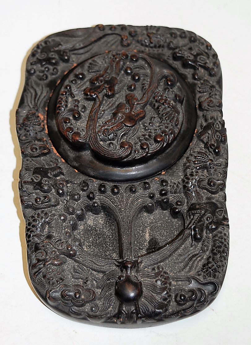 A Chinese clay caligraphy inkwell relief decorated with various dragons character mark verso,