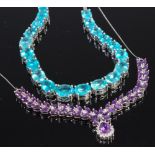 A silver and blue zircon set necklace together with a silver and amethyst set necklet on finelink