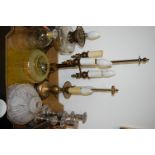 A box of various lighting to include two table lamps, a converted oil lamp, pair of candlesticks,