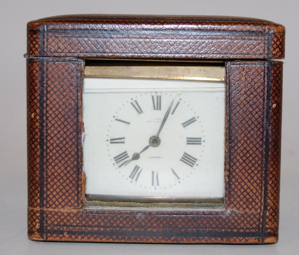 A mid-20th century brass cased carriage clock, having enamelled dial with Roman numerals,