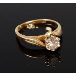 An 18ct gold diamond solitaire ring, the claw set brilliant weighing approx 0.6ct, 3.