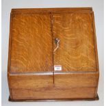 A late Victorian oak table top stationery cabinet having a hinged lid revealing perpetual calendar