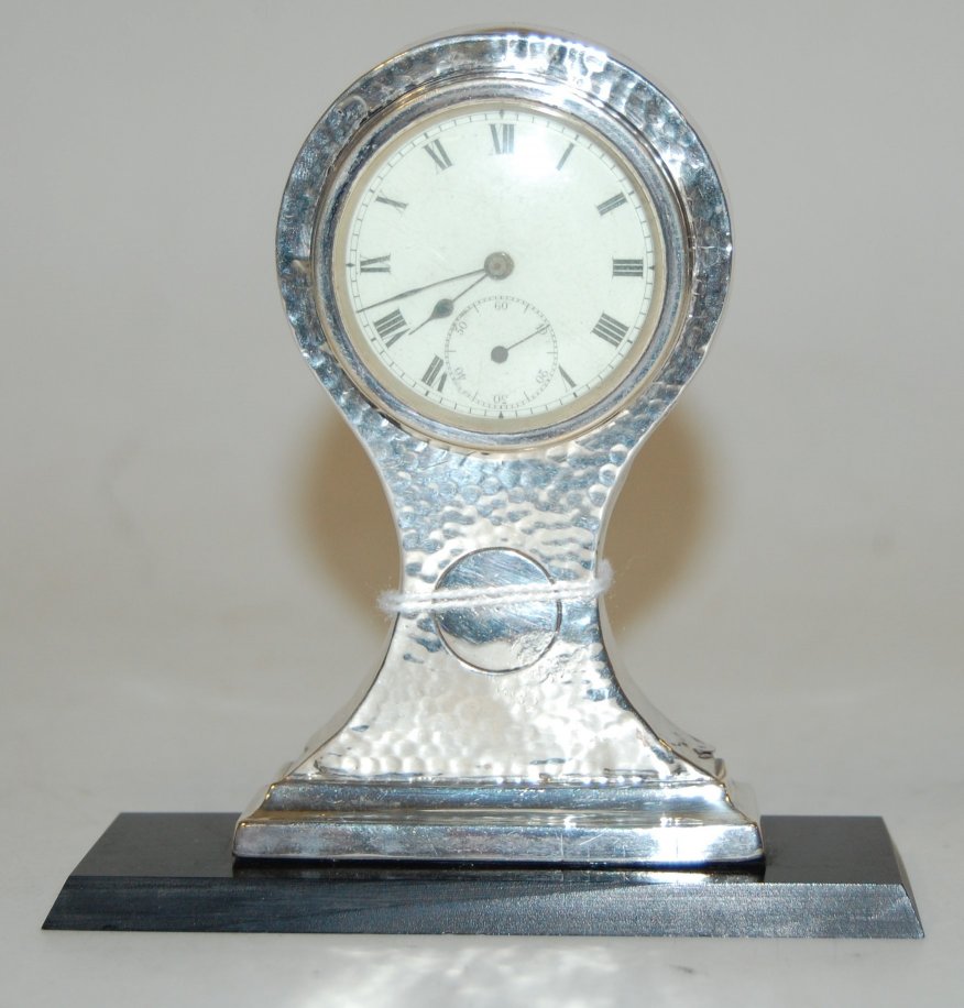 A George V hammered silver mounted balloon shaped mantel clock,