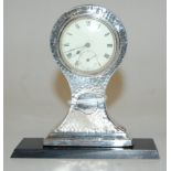 A George V hammered silver mounted balloon shaped mantel clock,