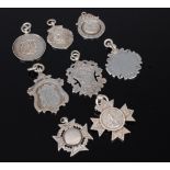 Eight various silver fob pendants to include sporting medals,
