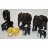 A collection of carved ebony elephant figures;
