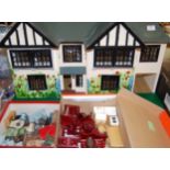 A childs Tudor style painted wooden dolls house;