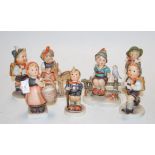 A collection of seven various Goebel figures to include School boy etc