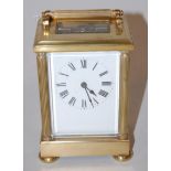 A 20th century lacquered brass cased carriage clock,