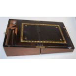 A Victorian walnut and brass bound writing slope having a fitted interior,