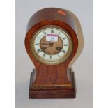 An Edwardian walnut balloon shaped mantel clock,