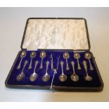 A cased set of eleven silver teaspoons with sugar bows, maker Walker & Hall,