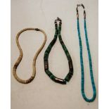 A turquoise set beaded necklace with white metal mount;