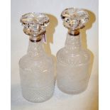A pair of 20th century cut glass decanters, each having silver mounted collar and mushroom stopper,