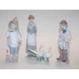 A collection of three Lladro figures, to include; girl with geese, clown, and boy with snails,