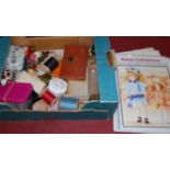 A collection of haberdashery items and patterns for dolls dress,