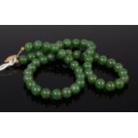 A beaded jade necklace with gilt metal clasp 42cm
