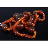 A clear orange amber necklace as large graduated barrel beads,