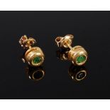 A pair of 14ct gold and emerald set ear studs,