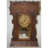 A late 19th century oak cased mantel clock by the Ansonia clock Company,