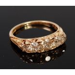 An 18ct gold and diamond five stone ring, the graduated old brilliants in a chased setting,
