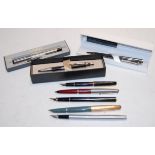 A small collection of assorted fountain and ballpoint pens,