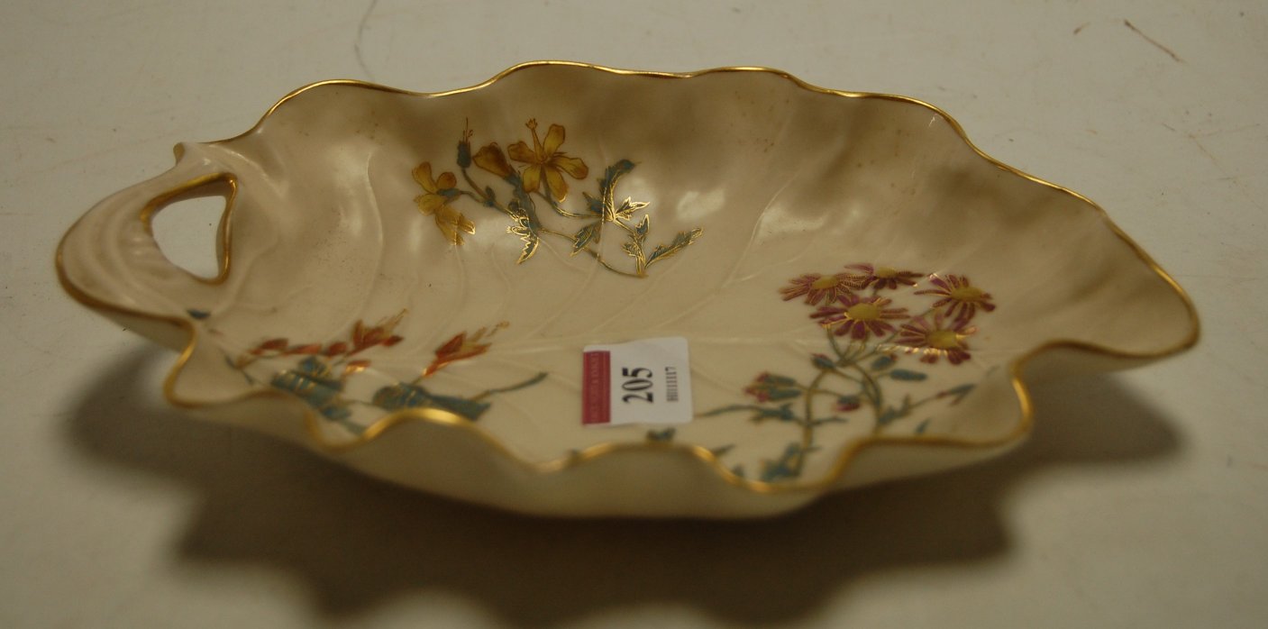 A circa 1890 Royal Worcester leaf dish with floral decoration within gilt borders having puce mark