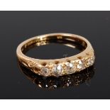 An 18ct gold diamond five stone ring, the graduated old cut diamonds in a chased line setting,