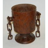 A large late Victorian treen pedestal goblet, having all-over carved leaf and acorn decoration,