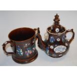 A large Victorian bargeware loving cup having typical treacle glaze and floral decoration,