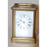 An early 20th century lacquered brass cased carriage clock,