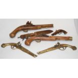 A reproduction ornamental flintlock pistol; together a brass decorative wall pistols,