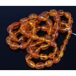 A beaded and graduated clear orange amber single string long necklace, 203g,