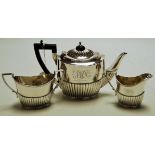A George V bachelors silver three-piece teaset, comprising teapot ,twin handled sugar and cream,