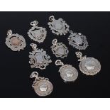 Nine various silver fob pendants to include sporting medals, some inscribed,