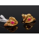 A pair of 18ct gold, ruby and three diamond set ear studs, 4.4g, 1.