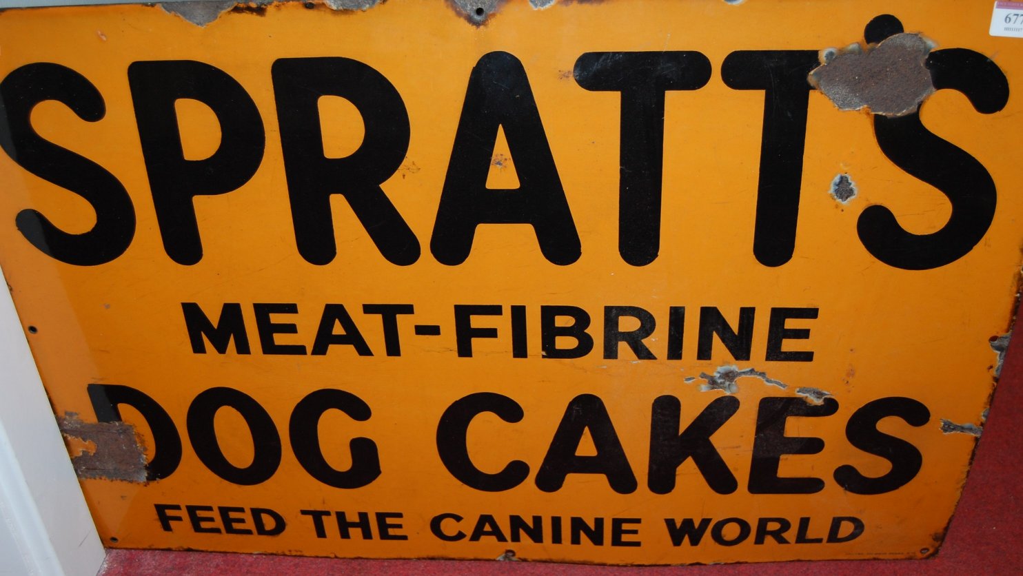 A mid-20th century enamelled advertising sign for Spratt's Meat Fibrine Dog Cakes,