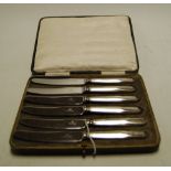 A cased set of six silver handled butter knives,