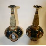 A pair of Royal Doulton stoneware vases having slender tapering neck to bulbous body on a mottled