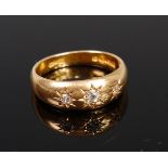 An 18ct gold and diamond gypsy ring, the centre old cut diamond weighing approx. 0.12ct, 5.